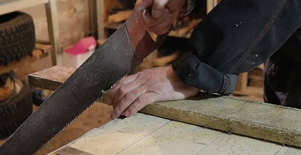 Carpenter sawing wood