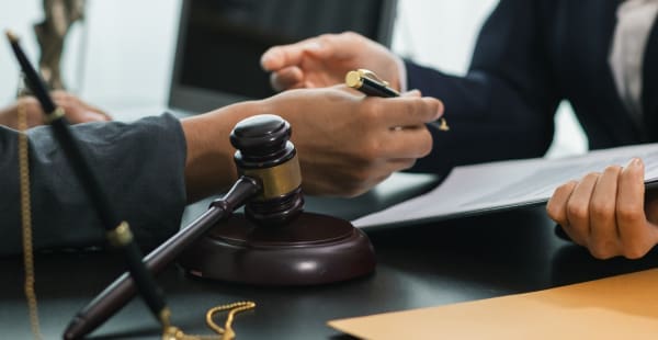 Lawyer and Client Signing Mesothelioma Claim Papers