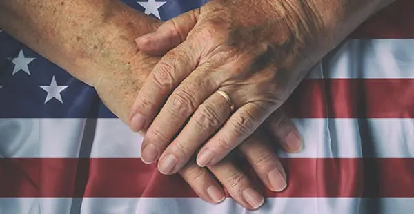 An image depicting hands over an American flag
