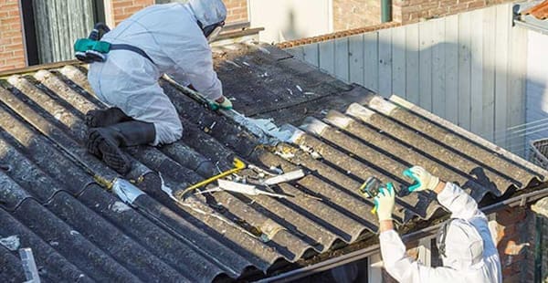An example of asbestos professionals working on a building with asbestos materials.