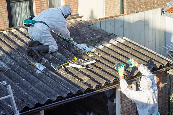 An example of asbestos professionals working on a building with asbestos materials.