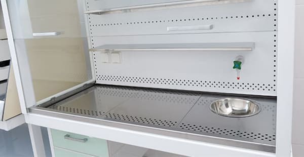 This image depicts a chemical fume hood that looks similar to older fume hoods that often contained asbestos as a fireproofing material.