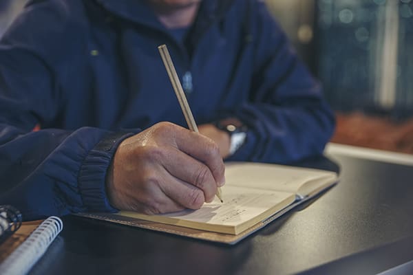 Mesothelioma patient signing end-of-life planning documents