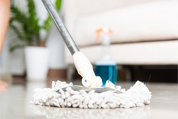 A picture of a mop on a floor as a cleaning service tidies up for a cancer patient.