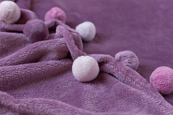 A photo of a snuggly, purple blanket that could be a gift for a mesothelioma patient.