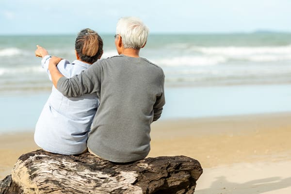 A photo of a couple on a gifted vacation gazing upon the ocean after a battle with mesothelioma.