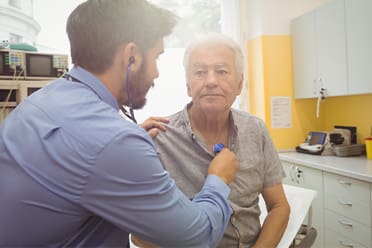 Photo of man being examined by a doctor