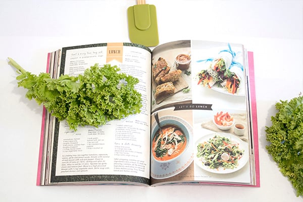 Picture of a cookbook with spatula and lettuce.