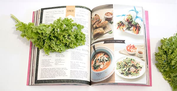Picture of a cookbook with spatula and lettuce.