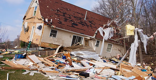 An image of a house after a hurricane, an event that could place people at risk of short-term asbestos exposure.