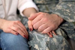 Veteran Mesothelioma patient holding hands with a loved one