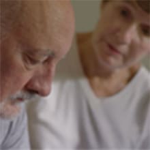 Still frame of a wife comforting her husband after a mesothelioma diagnosis from a video about Mesothelioma.com's free mesothelioma guide